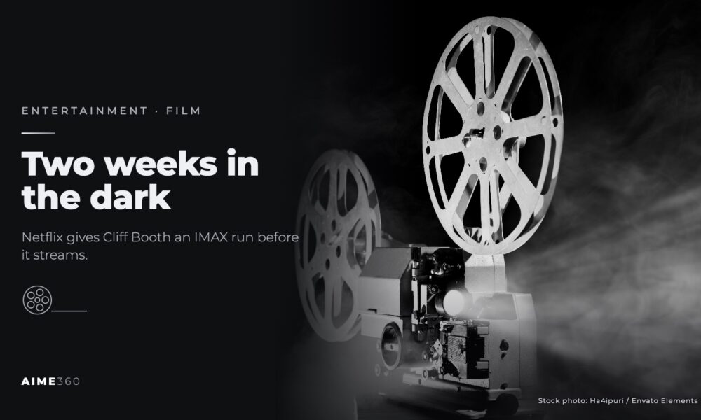 A vintage film projector shining through fog, in black and white, beside the headline Two weeks in the dark