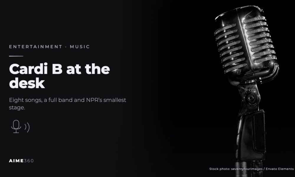 A vintage microphone under stage lights, in black and white, beside the headline Cardi B at the desk
