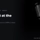 A vintage microphone under stage lights, in black and white, beside the headline Cardi B at the desk