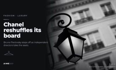 A street lamp on a Paris building facade, in black and white, beside the headline Chanel reshuffles its board