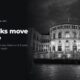The Norwegian Parliament building lit at night, in black and white, beside the headline The talks move to Oslo