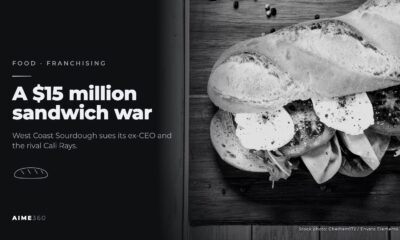 A baguette sandwich on a cutting board, in black and white, beside the headline A $15 million sandwich war