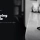 A cup of latte on a marble cafe counter, in black and white, beside the headline Not buying Chipotle