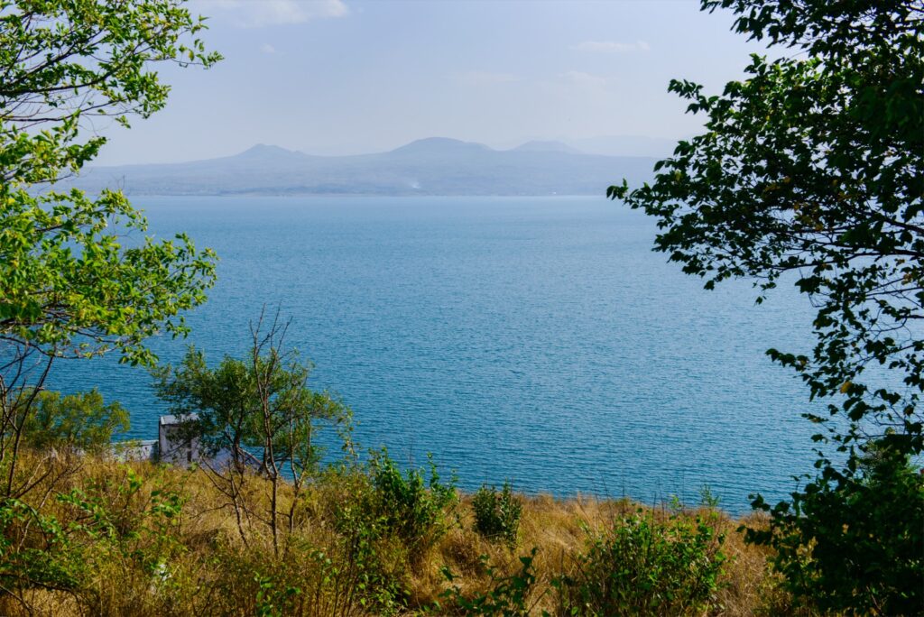 Lake Sevan framed by trees in summer