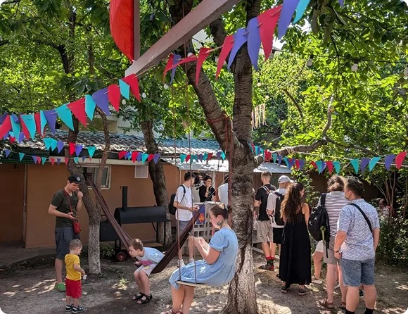 People in the garden courtyard of LAN Coworking in Yerevan
